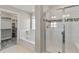 Bathroom features bathtub, tiled shower with glass door, white floor tiles and neutral paint at 1860 Chaffee Crest Dr, Berthoud, CO 80513