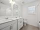 Elegant bathroom featuring double vanity sinks, white cabinets, and modern fixtures at 1860 Chaffee Crest Dr, Berthoud, CO 80513