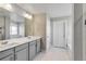 Bathroom featuring double sink vanity, large mirror, tile floor, bathtub and neutral paint at 1860 Chaffee Crest Dr, Berthoud, CO 80513