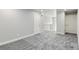 Bedroom featuring grey carpet, base trim, neutral paint and view of landing with staircase at 1860 Chaffee Crest Dr, Berthoud, CO 80513