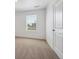 Bedroom showcasing neutral carpet, white walls, and a white door at 1860 Chaffee Crest Dr, Berthoud, CO 80513