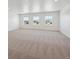 Expansive bonus room featuring neutral carpet and multiple windows offering natural light at 1860 Chaffee Crest Dr, Berthoud, CO 80513