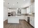 Modern kitchen with stainless steel appliances, an island, and white cabinetry at 1860 Chaffee Crest Dr, Berthoud, CO 80513