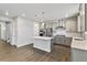 Modern kitchen features stainless steel appliances, an island, and sleek gray cabinetry at 1860 Chaffee Crest Dr, Berthoud, CO 80513