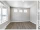 Sunlit living room features hardwood floors, neutral paint, large window and recessed lighting at 1860 Chaffee Crest Dr, Berthoud, CO 80513