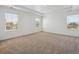 Bright main bedroom featuring neutral carpet and large windows offering natural light at 1860 Chaffee Crest Dr, Berthoud, CO 80513