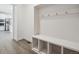 Mudroom with a built-in bench, coat hooks, and views of the kitchen at 1860 Chaffee Crest Dr, Berthoud, CO 80513