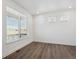 Bright room with hardwood floors and a large window with horizontal blinds at 1860 Chaffee Crest Dr, Berthoud, CO 80513
