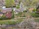 Aerial view shows a residential area with homes, yards, and a winding creek at 2435 Creighton Dr, Golden, CO 80401