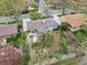 Aerial view showing a backyard with mature trees, a green lawn, and a concrete patio at 2435 Creighton Dr, Golden, CO 80401