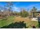 Large backyard with lush grass, mature trees and a patio area at 2435 Creighton Dr, Golden, CO 80401