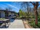 Backyard patio with an outdoor dining table and beautiful landscaping at 2435 Creighton Dr, Golden, CO 80401
