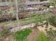 Aerial view displays a backyard with seating around a fire pit and lush foliage at 2435 Creighton Dr, Golden, CO 80401