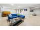 Spacious basement area with a comfortable sofa, piano, and versatile layout for various activities at 2435 Creighton Dr, Golden, CO 80401