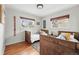 Comfortable bedroom showcasing hardwood floors, natural light, and twin beds with rustic wood frames at 2435 Creighton Dr, Golden, CO 80401