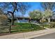 Charming home with fenced yard, lush green grass, and flowering trees providing shade and beauty at 2435 Creighton Dr, Golden, CO 80401