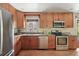 Well-appointed kitchen features stainless steel appliances, wooden cabinetry, and granite countertops at 2435 Creighton Dr, Golden, CO 80401