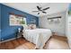 Comfortable main bedroom with natural light, hardwood floors, and accent wall at 2435 Creighton Dr, Golden, CO 80401