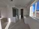 Modern bathroom with a glass shower, white cabinets, and a large window for natural light at 5685 Farrier Pt, Castle Rock, CO 80104