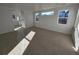 Bright bedroom with large windows and neutral carpet, with a partial view of an en-suite bathroom at 5685 Farrier Pt, Castle Rock, CO 80104