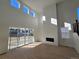 Bright living room featuring floor-to-ceiling windows and a modern fireplace at 5685 Farrier Pt, Castle Rock, CO 80104