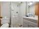 Bright bathroom with a modern glass shower, neutral tile, and a gray vanity at 1173 Ski Hill Rd # 127, Breckenridge, CO 80424