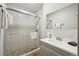 Modern bathroom with a glass-enclosed shower featuring neutral tile, with a gray vanity at 1173 Ski Hill Rd # 127, Breckenridge, CO 80424