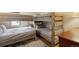 Bedroom with built-in bunk beds, wood floors, and cozy decor at 1173 Ski Hill Rd # 127, Breckenridge, CO 80424