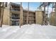 Exterior of condo building featuring balconies and snow-covered walkway and surroundings at 1173 Ski Hill Rd # 127, Breckenridge, CO 80424