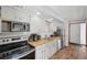 Functional kitchen with wooden countertops, white cabinets, and stainless steel appliances at 1173 Ski Hill Rd # 127, Breckenridge, CO 80424