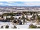 Expansive mountain views highlight this community with mature trees and homes nestled in a snow-covered landscape at 7863 Windfont Row, Parker, CO 80134