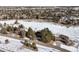 Aerial view of property surrounded by mature trees in a snowy landscape with neighboring houses at 7863 Windfont Row, Parker, CO 80134