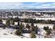 An elevated view showing the house nestled within a community with mountain views beyond at 7863 Windfont Row, Parker, CO 80134