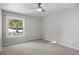 Bright bedroom with ceiling fan and neutral-toned carpet at 7863 Windfont Row, Parker, CO 80134