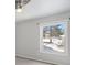 Serene bedroom featuring a large window offering natural light and scenic outdoor views at 7863 Windfont Row, Parker, CO 80134