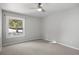 Serene bedroom featuring a large window offering natural light and scenic outdoor views at 7863 Windfont Row, Parker, CO 80134