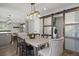Dining area with view to kitchen, rustic sliding barn door and convenient laundry closet at 7863 Windfont Row, Parker, CO 80134