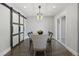 Bright dining room with modern lighting, sliding glass door and rustic barn door at 7863 Windfont Row, Parker, CO 80134