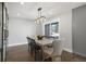 Bright dining room with sliding barn doors and industrial light fixture at 7863 Windfont Row, Parker, CO 80134