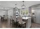 Stylish kitchen with stainless steel appliances, island seating, modern pendant lights, and open dining area at 7863 Windfont Row, Parker, CO 80134