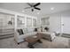 Bright living room boasts plush sectional sofa, recessed lighting, and built-in shelving for a cozy and inviting atmosphere at 7863 Windfont Row, Parker, CO 80134