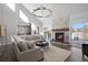Spacious living room featuring a cozy fireplace and large windows at 7863 Windfont Row, Parker, CO 80134
