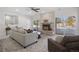 Inviting living room featuring a brick fireplace, neutral-toned sofa, and sliding glass doors with backyard view at 7863 Windfont Row, Parker, CO 80134