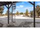 Exterior spiral staircase leading to backyard with snow at 7863 Windfont Row, Parker, CO 80134