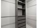 A well-organized walk-in closet with shelving, drawers, and ample hanging space for optimal storage solutions at 7863 Windfont Row, Parker, CO 80134