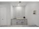 A well-lit wet bar with modern subway tile backsplash, stylish cabinetry, and sleek countertops, perfect for entertaining at 7863 Windfont Row, Parker, CO 80134