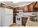 Updated kitchen with white appliances, wood cabinets, and granite countertops at 610 S Alton Way # 8D, Denver, CO 80247