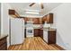 Efficient kitchen with white appliances and ample wood cabinetry at 610 S Alton Way # 8D, Denver, CO 80247
