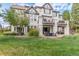 Exterior of the home showcasing the well-maintained lawn, patio, and upper-level decks at 618 Fairchild Dr, Highlands Ranch, CO 80126