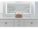 Bright bathroom boasts a double vanity with an illuminated mirror at 618 Fairchild Dr, Highlands Ranch, CO 80126